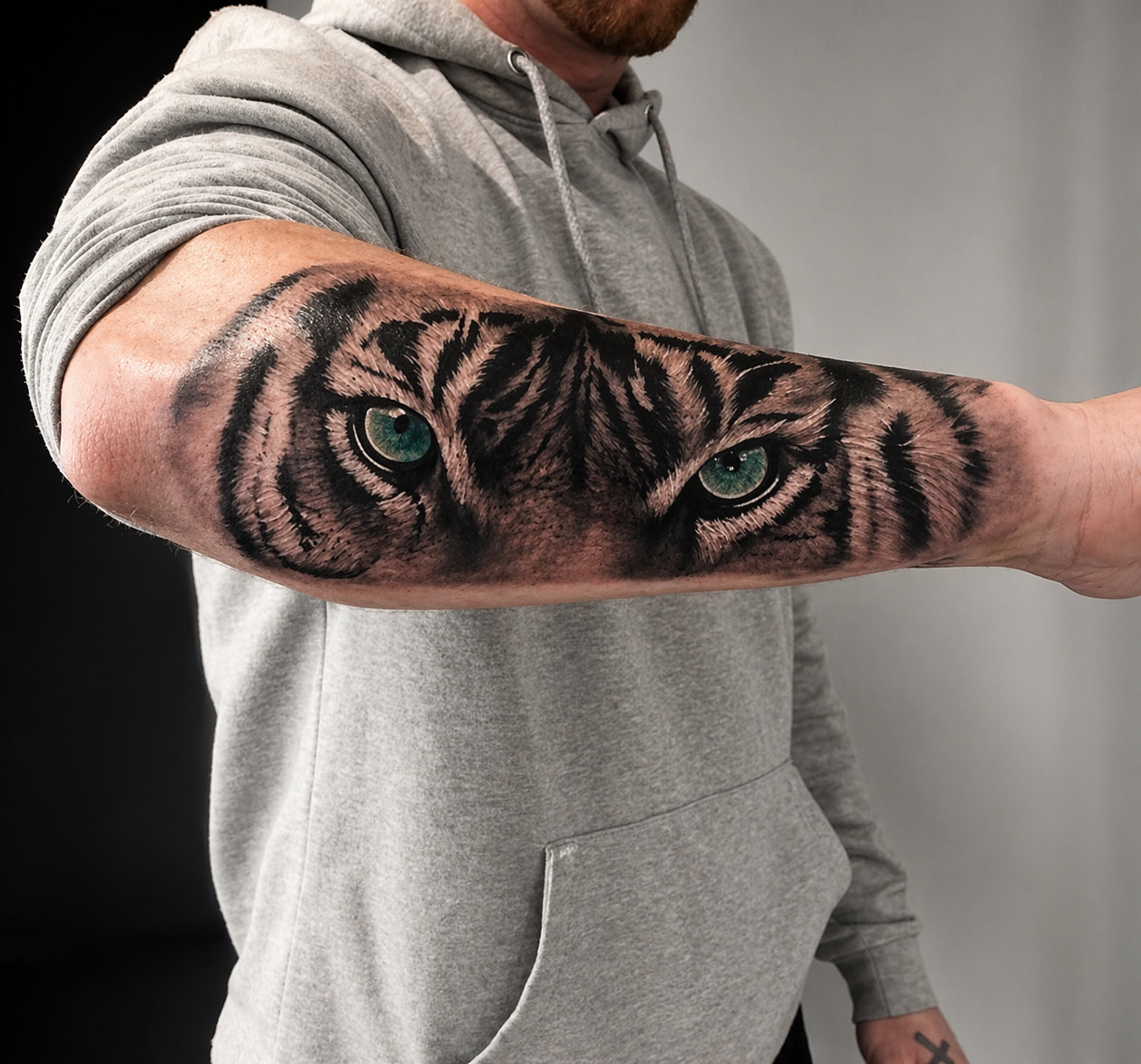 Tiger eyes forearm tattoo with black and grey shading by Rondon Neto