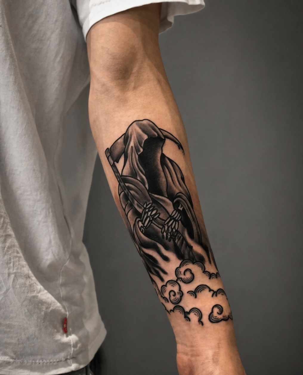 Black and grey grim reaper forearm tattoo by Rondon Neto