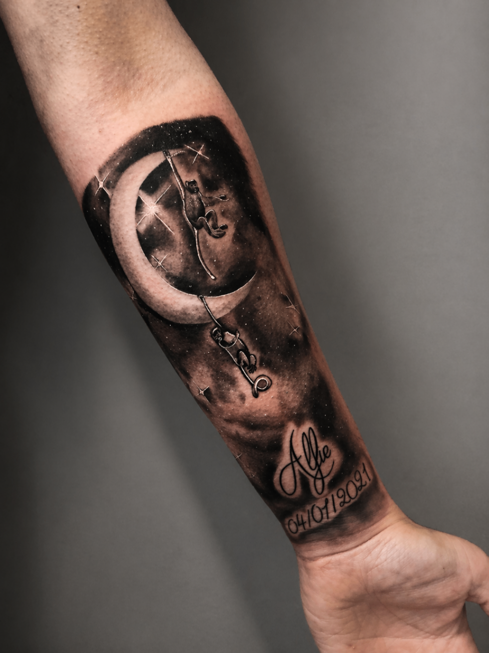 Black and grey crescent moon and stars forearm tattoo by Rondon Neto