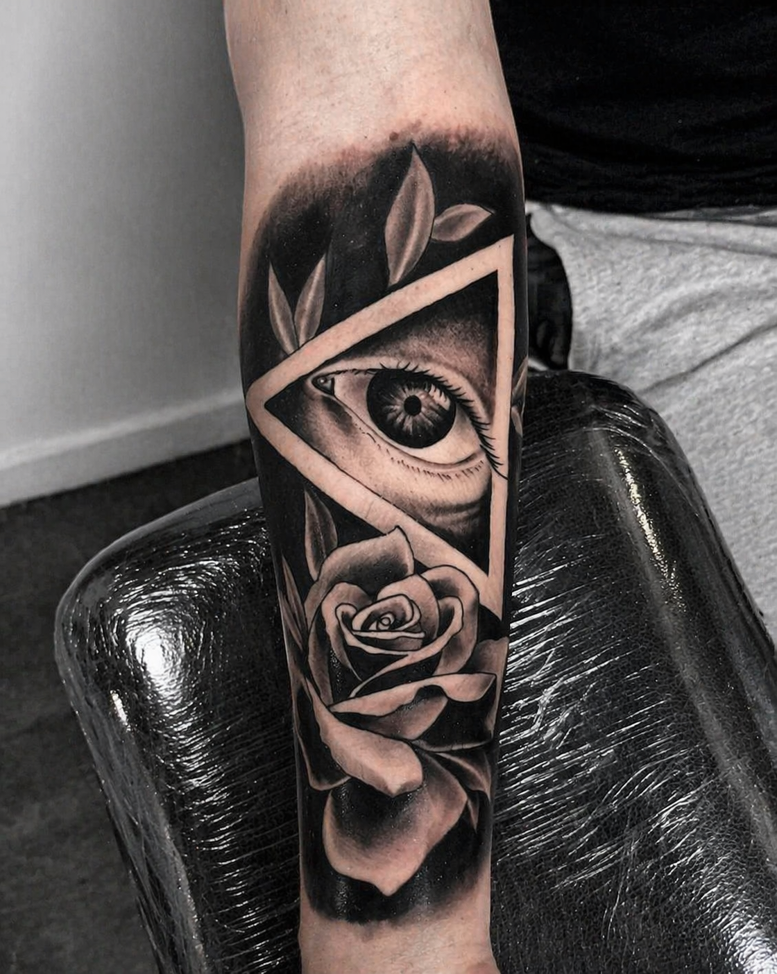 Black and grey eye and rose forearm tattoo by Rondon Neto