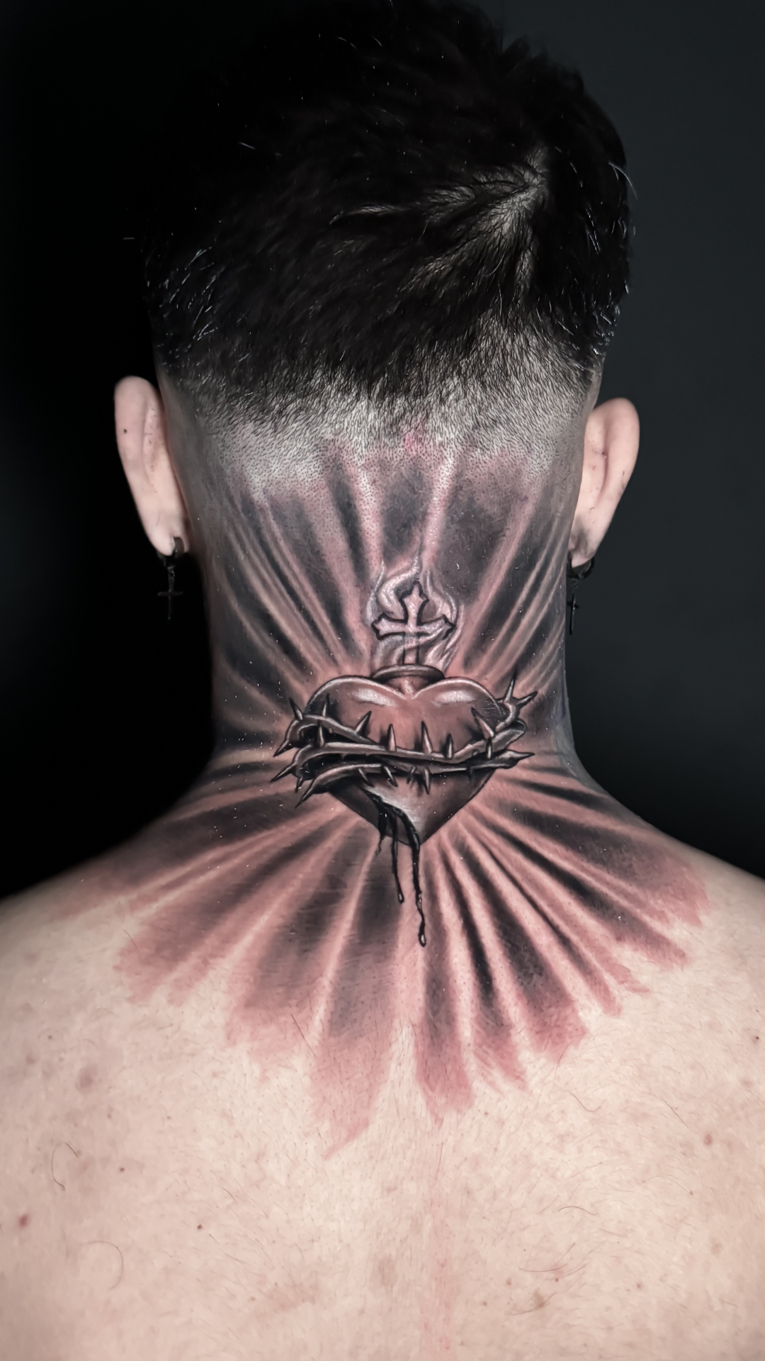 Sacred heart nape and neck tattoo with rays by Rondon Neto