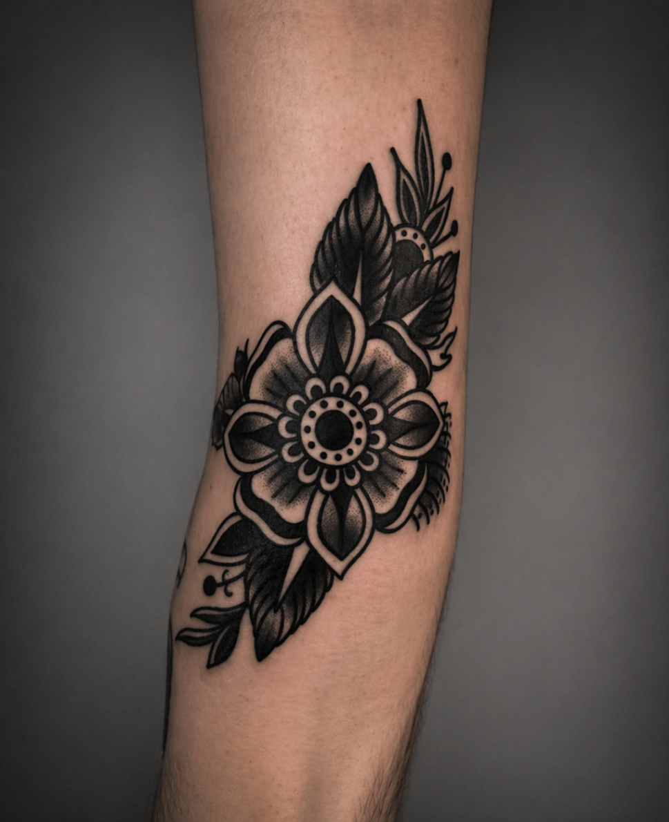 Ornamental floral blackwork forearm tattoo by Rondon Neto
