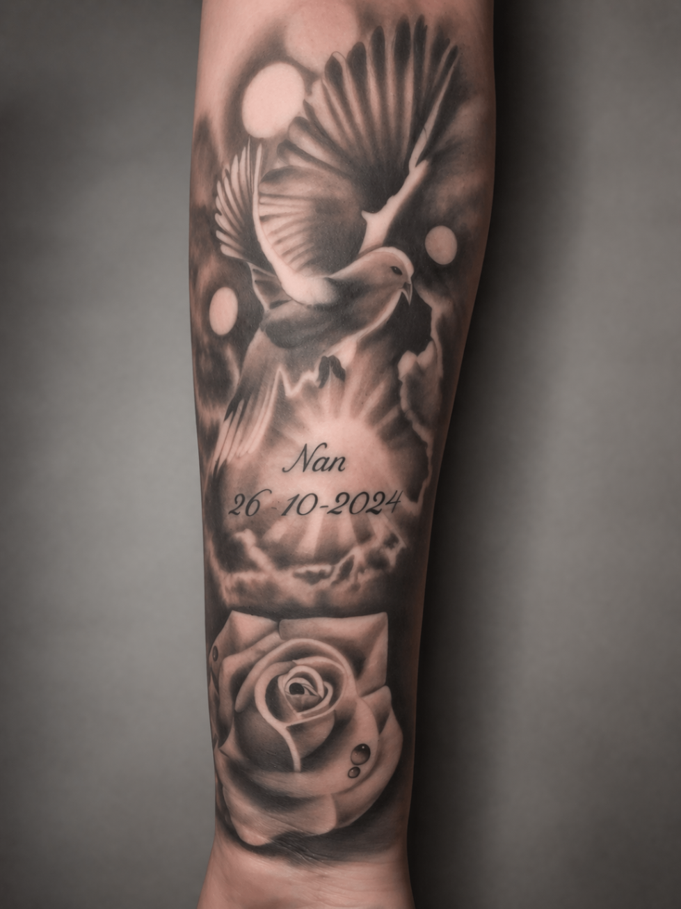 Black and grey memorial dove and rose forearm tattoo by Rondon Neto