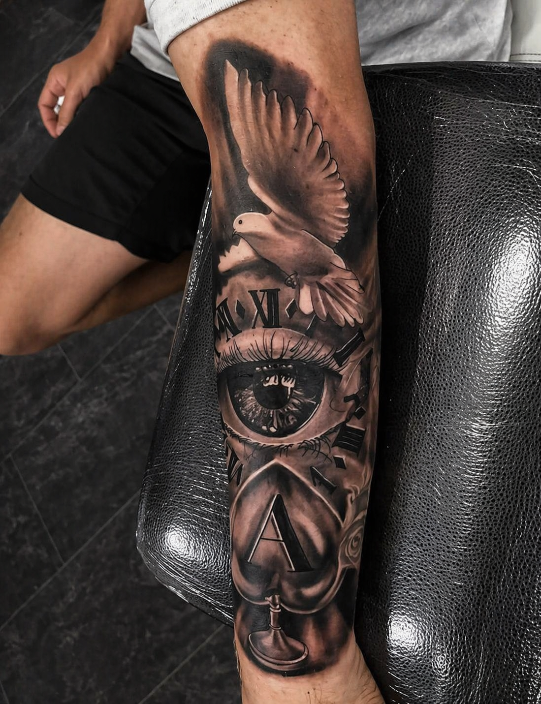 Black and grey dove, eye and clock forearm tattoo by Rondon Neto