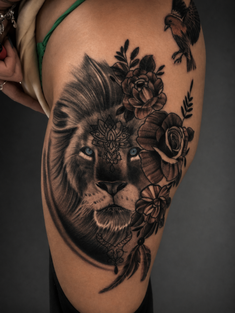 Black and grey lion and floral thigh tattoo by Rondon Neto